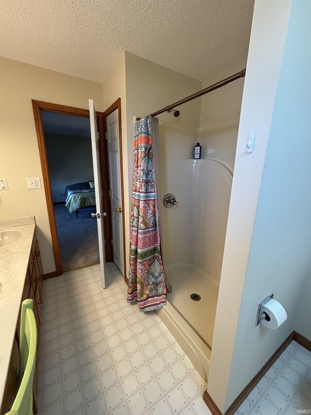 full bathroom with tile patterned floors, a textured ceiling, vanity, and a shower with curtain