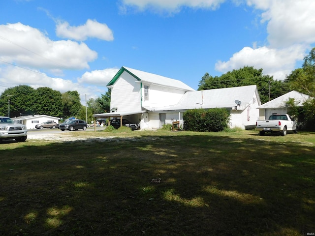 view of side of home with a lawn