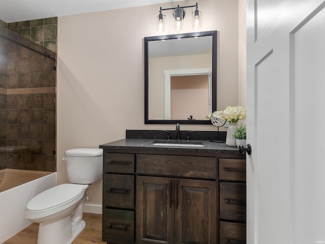 full bathroom with toilet, wood finished floors, shower / bath combination, baseboards, and vanity