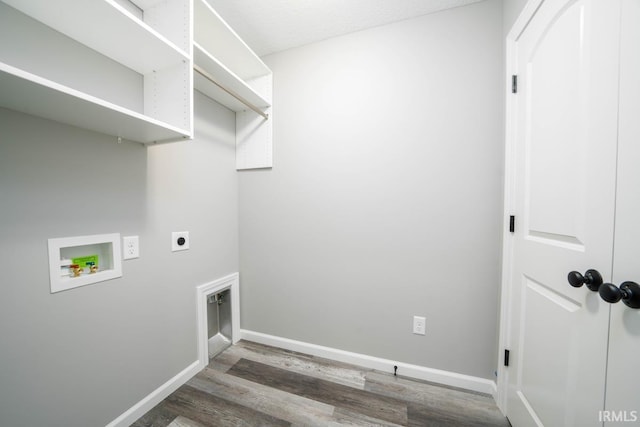 clothes washing area featuring hookup for a washing machine, wood finished floors, baseboards, laundry area, and electric dryer hookup