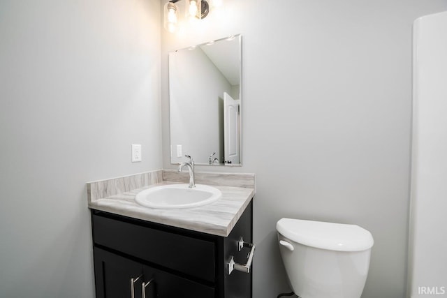 half bathroom with toilet and vanity