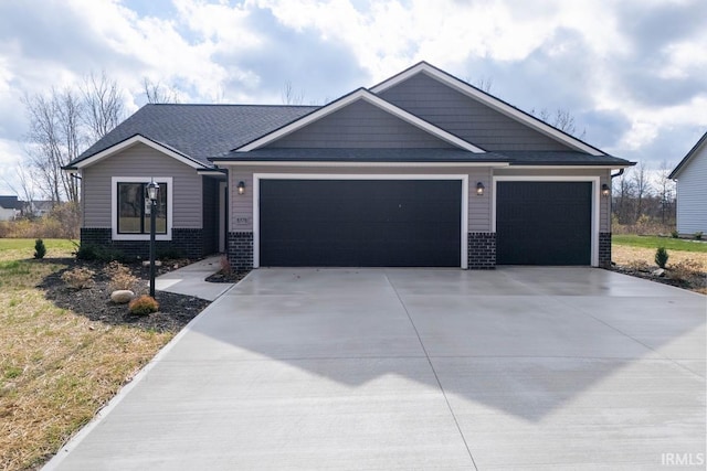 view of front facade with concrete driveway, brick siding, and a garage