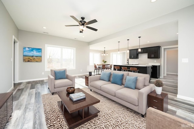 living area with recessed lighting, baseboards, and light wood-style floors