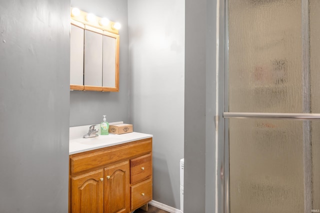 bathroom featuring a stall shower and vanity