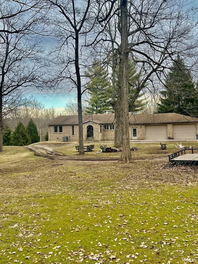 exterior space featuring a garage and a lawn