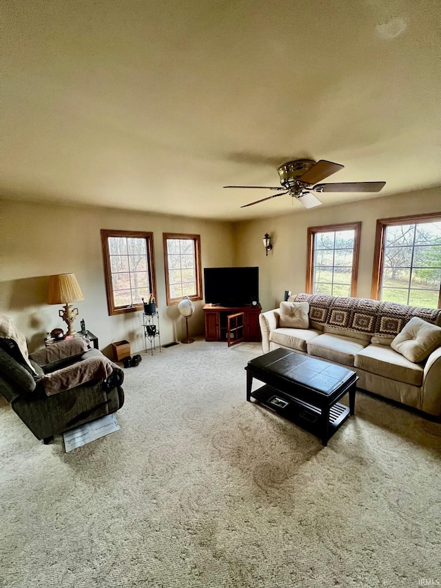 living room featuring a ceiling fan and carpet flooring