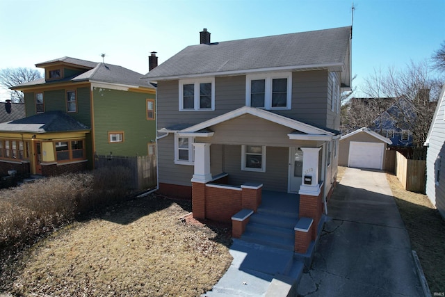 traditional style home featuring an outbuilding, fence, driveway, covered porch, and a detached garage