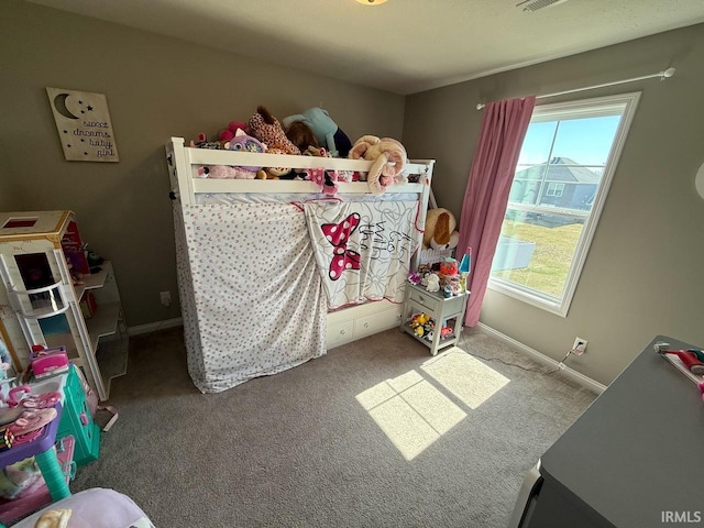 carpeted bedroom featuring baseboards