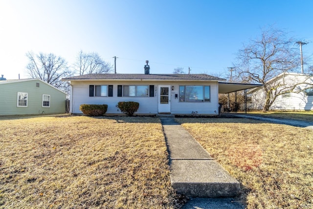 view of front of home with an attached carport and a front yard