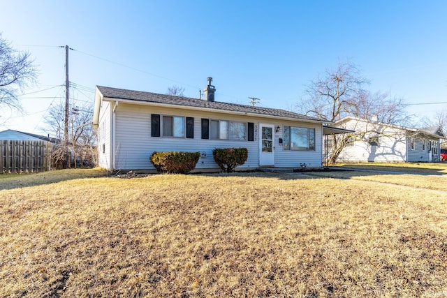 ranch-style home with a front lawn and fence