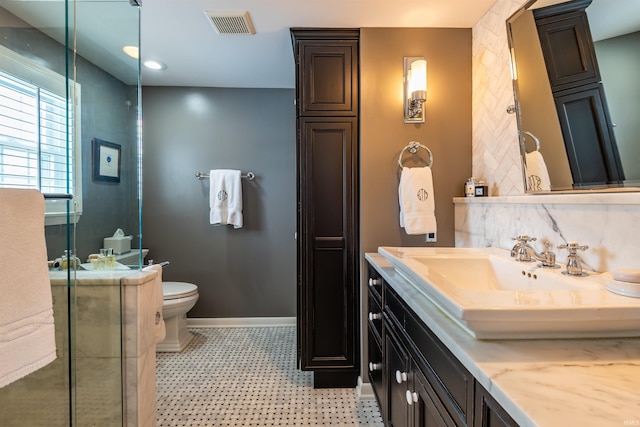 full bathroom with visible vents, baseboards, toilet, tile patterned floors, and vanity