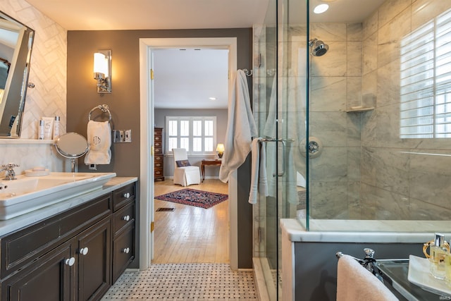 bathroom featuring a shower stall and vanity