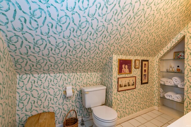 bathroom featuring baseboards, toilet, tile patterned flooring, and wallpapered walls