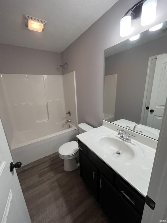 full bath featuring vanity, toilet, shower / bathing tub combination, and wood finished floors