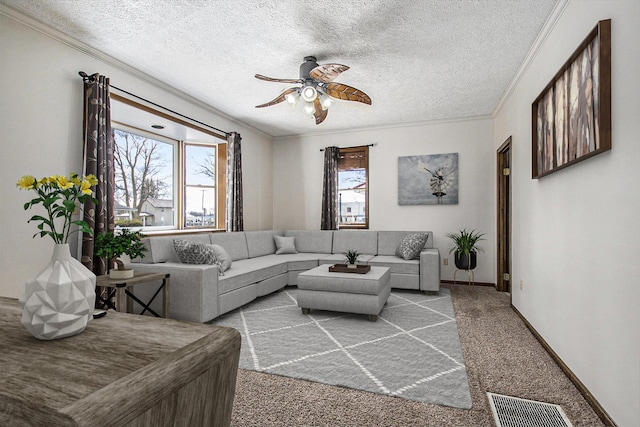 carpeted living area featuring a wealth of natural light, a textured ceiling, and ornamental molding