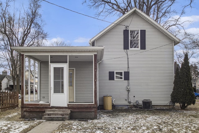 back of property with a porch, central AC, and fence