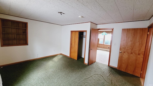 unfurnished bedroom with a baseboard radiator, baseboards, carpet, and a closet