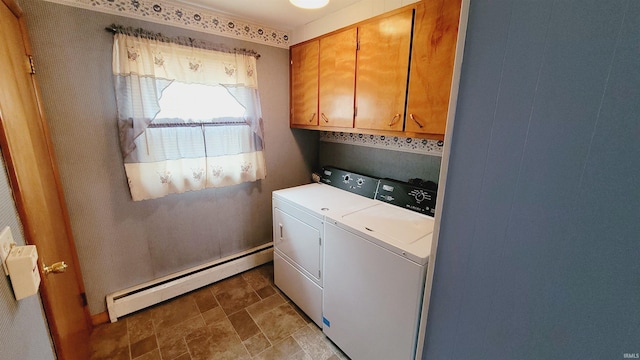 washroom featuring a baseboard radiator, cabinet space, separate washer and dryer, and stone finish floor