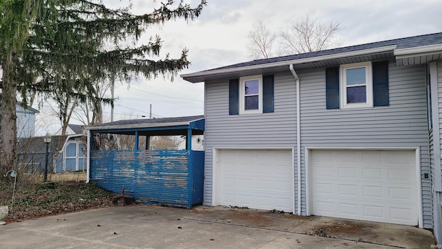 view of front of property with concrete driveway and an attached garage