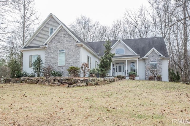 view of front of house featuring stone siding and a front yard