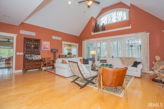 living area with wood finished floors, visible vents, and ceiling fan