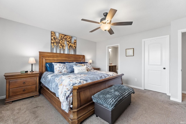 carpeted bedroom featuring ceiling fan, connected bathroom, and baseboards