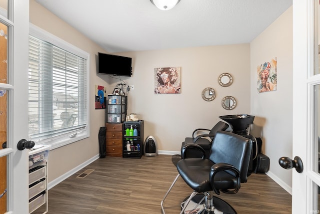 home office featuring visible vents, baseboards, and wood finished floors