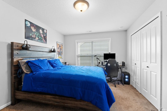 carpeted bedroom featuring visible vents, a closet, and a textured ceiling