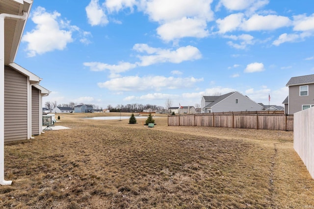 view of yard with a residential view and fence