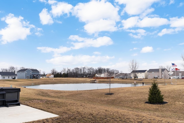 view of yard featuring a residential view and a water view