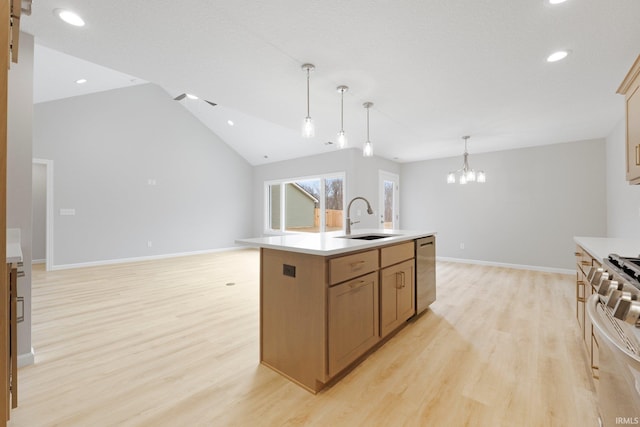 kitchen with a sink, stainless steel appliances, light wood-type flooring, and vaulted ceiling