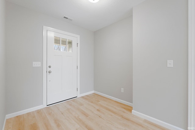 entrance foyer featuring baseboards, visible vents, and light wood finished floors