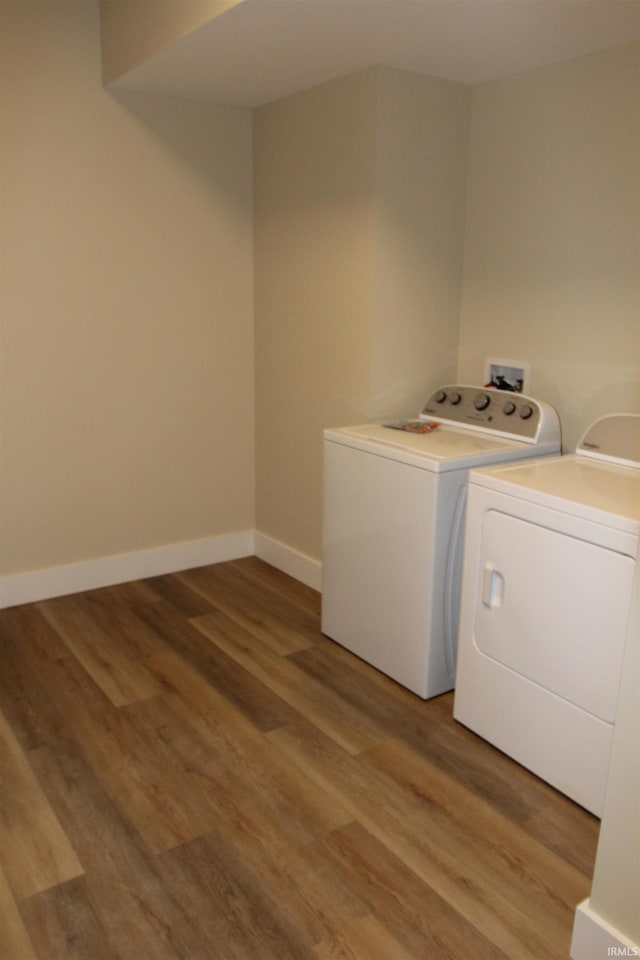 534 E Dogwood Ct, Spencer, IN 47460 - washroom with baseboards, light wood-style floors, laundry area, and washer and clothes dryer