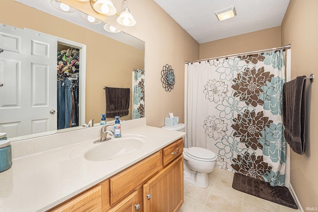 bathroom featuring tile patterned flooring, toilet, vanity, and visible vents