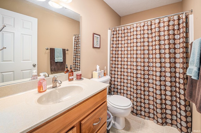 bathroom featuring toilet, vanity, a shower with curtain, tile patterned floors, and a textured ceiling