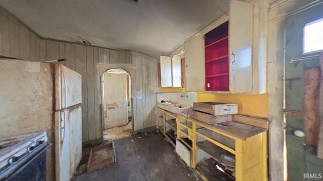 kitchen featuring range with gas cooktop and freestanding refrigerator