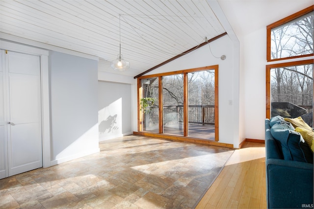 living room featuring vaulted ceiling, wooden ceiling, baseboards, and a wealth of natural light