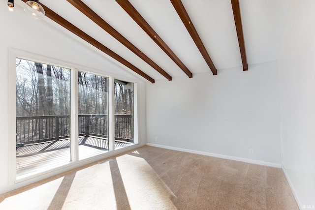 carpeted spare room featuring vaulted ceiling with beams and baseboards