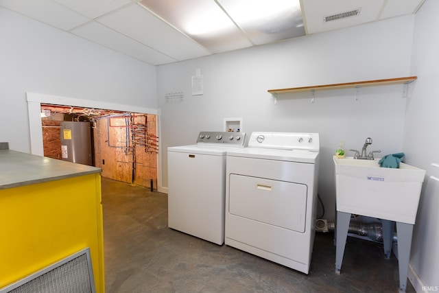 laundry room with visible vents, a sink, water heater, laundry area, and washing machine and clothes dryer