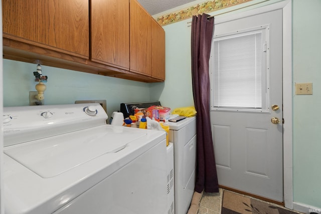 clothes washing area featuring cabinet space and separate washer and dryer