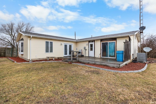 rear view of property featuring central air condition unit, french doors, a yard, and fence