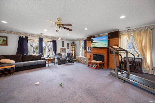 living room with carpet, a fireplace, and a textured ceiling