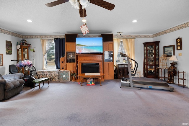 living area with ceiling fan, carpet, recessed lighting, a fireplace, and a textured ceiling