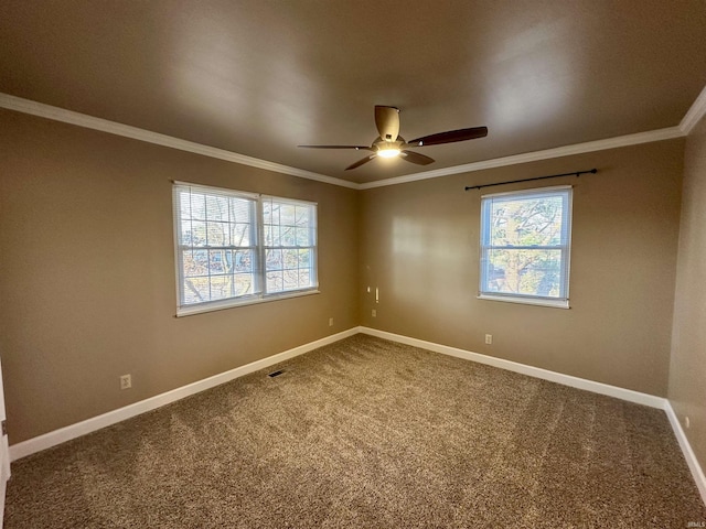 carpeted empty room with ceiling fan, crown molding, and baseboards