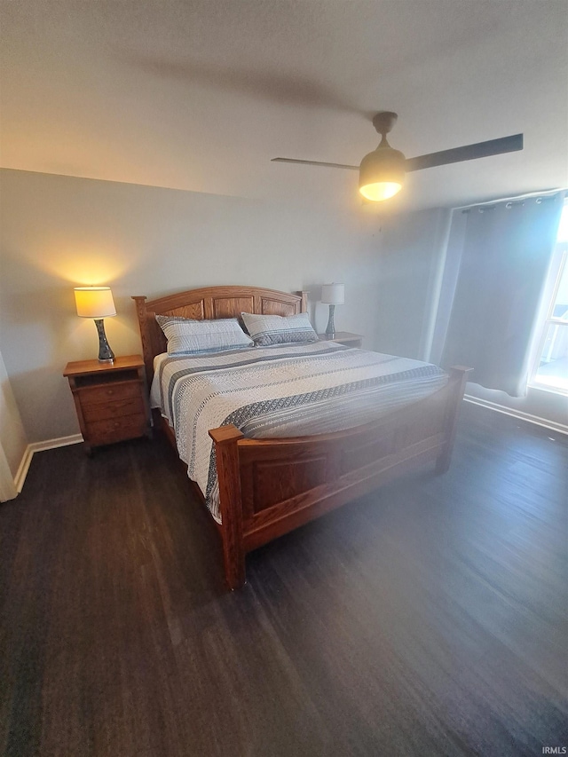 bedroom featuring wood finished floors, baseboards, and ceiling fan