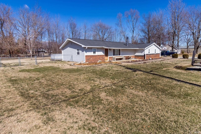 exterior space with brick siding, a lawn, and fence