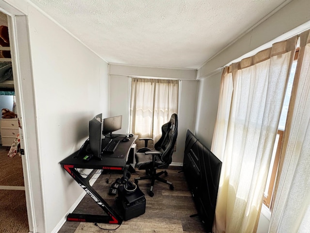 office space with a textured ceiling, baseboards, and wood finished floors