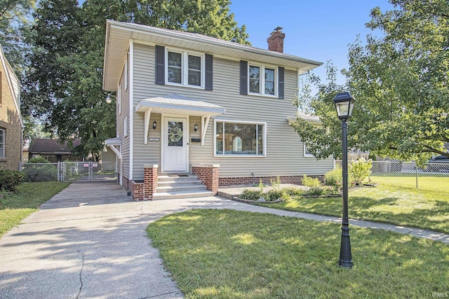 view of front of property featuring a front yard, fence, driveway, and a chimney