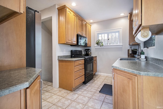 kitchen featuring light tile patterned floors, baseboards, recessed lighting, a sink, and black appliances