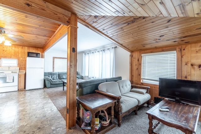 living room featuring wooden ceiling, a ceiling fan, wood walls, and vaulted ceiling